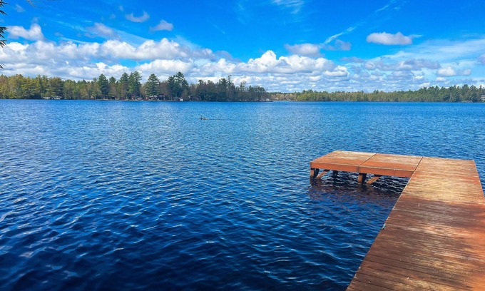 Three Lakes Cabin | Dog-friendly lakefront property with dock, boat lift, firepit, & two kitchens