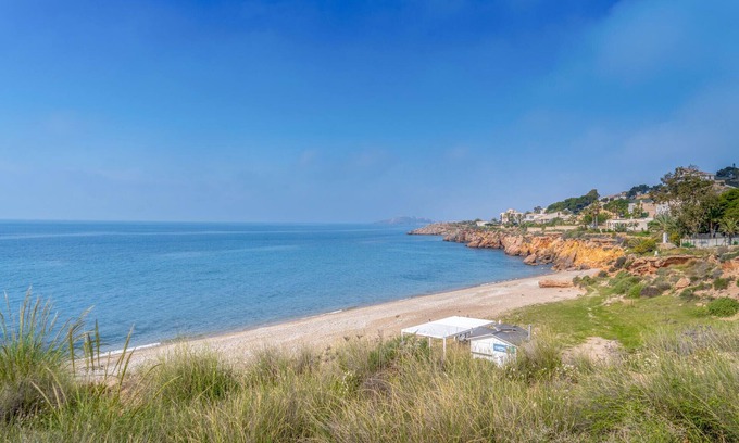 Los Puertos Apartment | Enjoy a relaxing vacation by the sea in this vacation apartment with a beautiful conservatory.