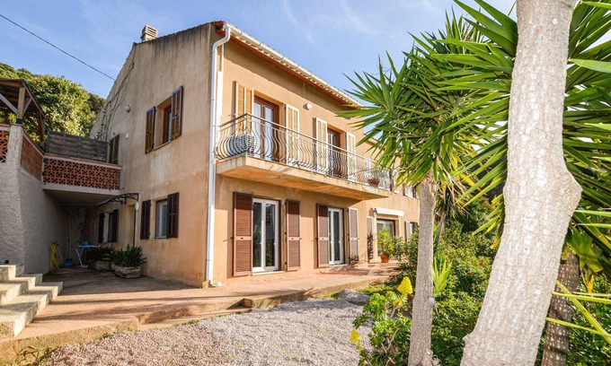 Cargese Apartment | Enjoy an enchanting view of the countryside in this appealing vacation apartment near the sea.