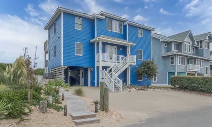 Ocean Sands House | Experience luxury at 1861 - Into the Mystic, a spacious 6-bedroom oceanfront home in Corolla, NC.