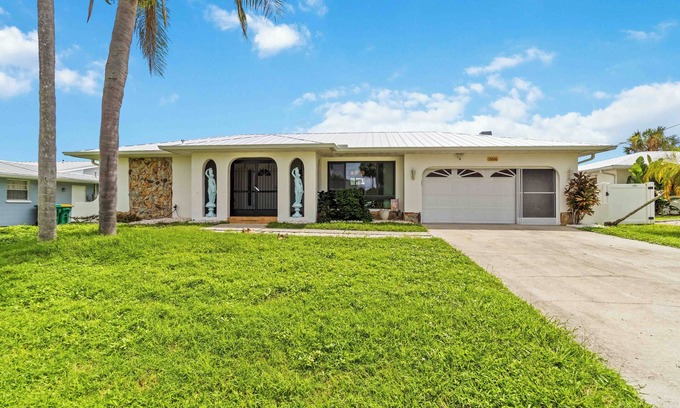 Port Charlotte House | Experience serenity in this fully furnished 3-bed, 3-bath waterfront home featuring a heated pool, spacious layout, and abundant natural light. Enjoy stunning water views from the master suite, living room and Florida room.