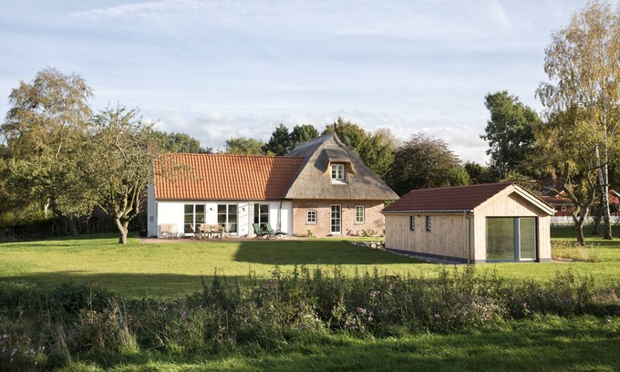 Holzdorf House | Family idyll under thatch with stove and sauna