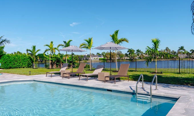 Palm River Estates House | Fully Updated Lake Front Home With Heated Pool!