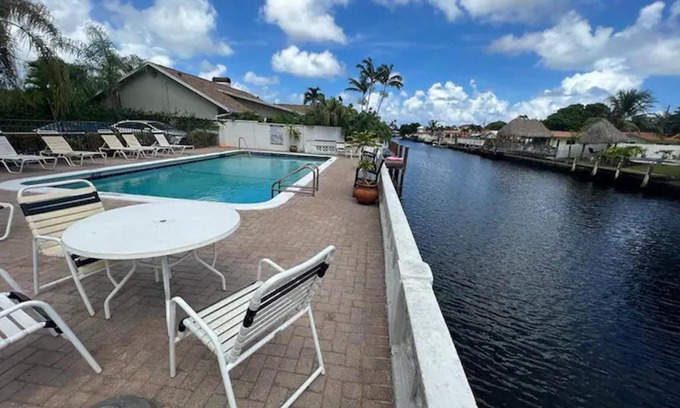Coral Ridge Isles House | Great room with swimming pool and great views