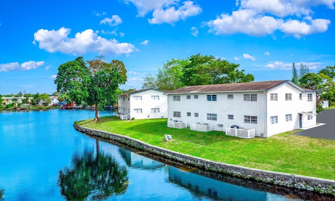 Survey Creek Apartment | Ground Floor - Water View - Palm Wave Says