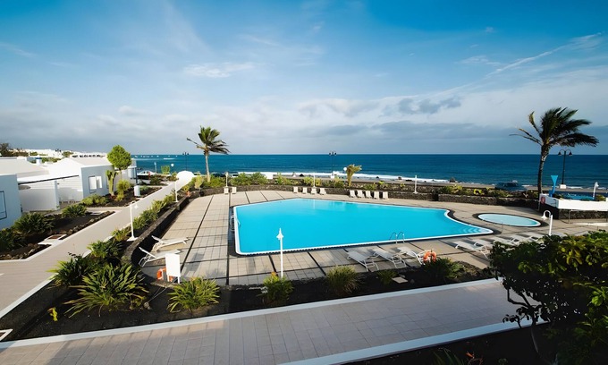 Arrieta House | Holiday Home 'Caleta Campos 2' with Sea View, Shared Pool and Wi-Fi