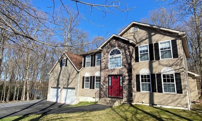 East Stroudsburg House | Lake Adjacent Home w/Hot Tub, Game Room, Boats, Fenced Yard