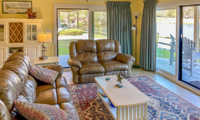 Sea Trail Condo | Lakefront condo with patio, AC, & water views plus pool & tennis