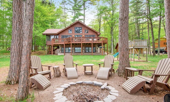 Conover House | Lakefront dog-friendly home with firepit, play set, dock, & beach access