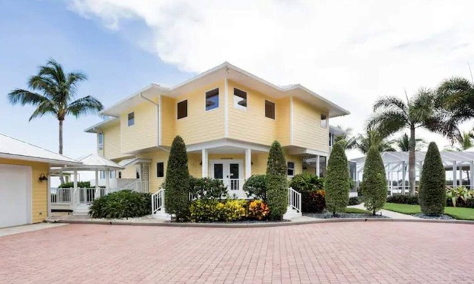 Palm City House | Lush Waterfront Pool Home and Pool house with Pickleball court and Boat dock