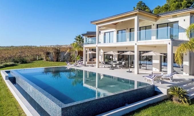 Plaissan Villa | Luxury SCL villa heated mirror pool exotic garden vineyard