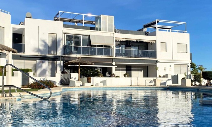 Orihuela Costa Apartment | Modern flat with swimming pool, terrace and equipped solarium