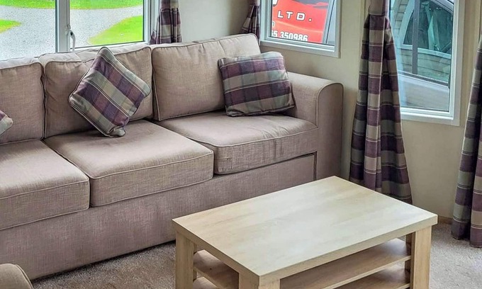 Arnold House | Modern holiday home with a large comfortable living area and dining area.