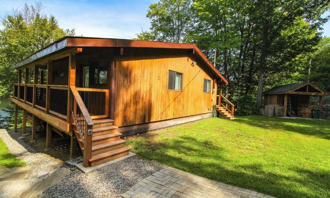 Dysart et al Cottage | Modern log cabin with wrap around deck on Little Kennisis