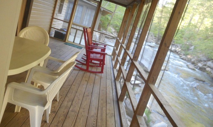Bat Cave Cottage | On the River's Edge! Rocking chairs on large screened porch on river's edge.