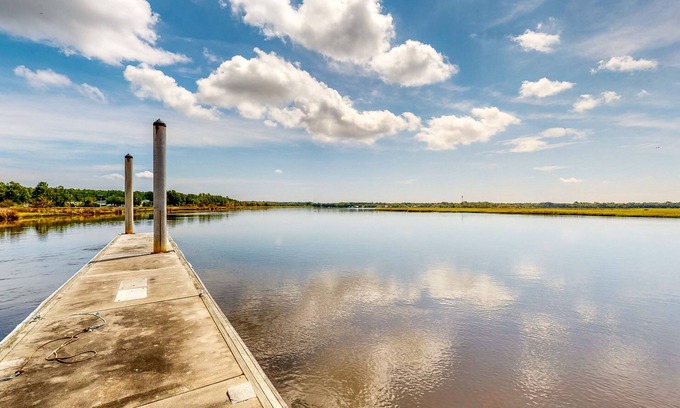 St. Marys House | Palm-lined home with dock access, firepit & inviting balconies