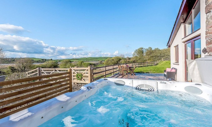 Ferryside Cottage | Picked for its luxury finish inside, stunning estuary views and a private hot tub.