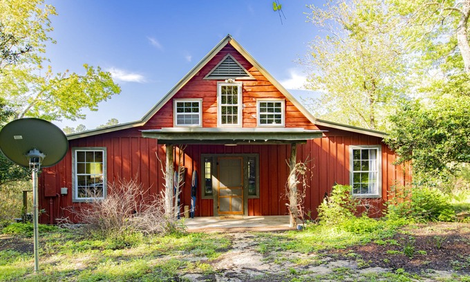 Fairhope Cabin | Private cabin built over a lake with a large breezy screened-in porch.