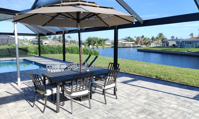Caloosahatchee House | Private enclosed heated pool with Gulf access. Panoramic Lenai