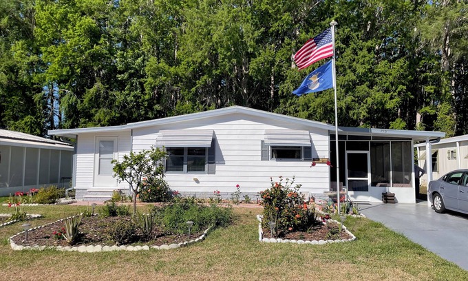 Wildwood House | Relax in style—lanai, golf cart & tranquil wooded views included!