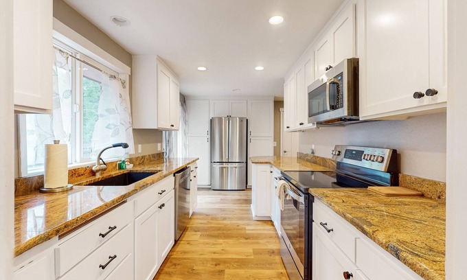 Union House | Remodeled home with game room, modern amenities, & golf course views