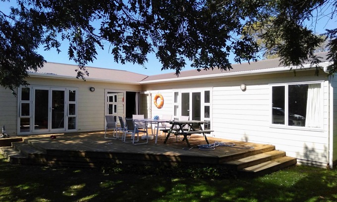 Waitarere Beach House | Renovated oasis with large deck and leafy privacy