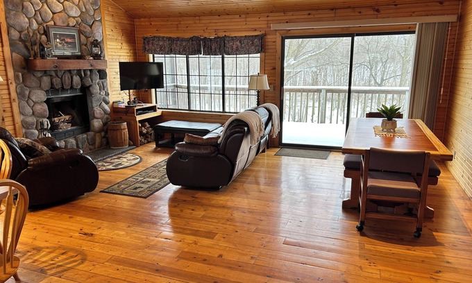 South Haven Cottage | Riverbend Retreat Middle Branch CottagenFireplace and hot tub with river view.