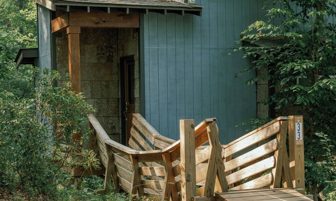 Mill Spring House | Romantic treehouse nestled on the creek, private deck, loft bedroom, shower skylights, bridge, sleeps 3.
