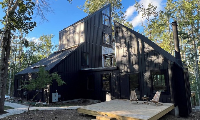 Michaywe House | Step into Time Capsule Tower, a retro 70s escape with 5 themed bedrooms, movie room, hot tub, sauna, arcade & more. Centrally located near Northern Michigan golf, lakes, skiing, & off-road and snowmobile trails with access to a community pool.
