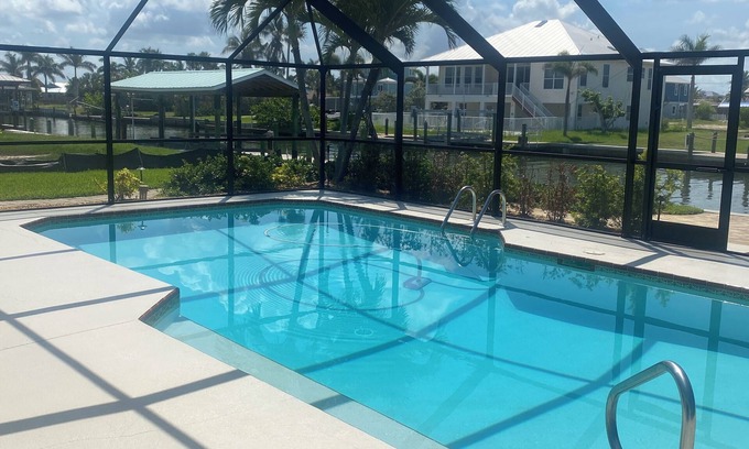 South Island House | Sunny Getaway – Heated Pool, Canal Views, Walk to Beach