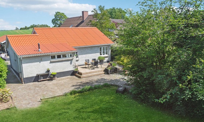 Vemmelev House | Surrounded by green meadows and fields, this inviting vacation home in Westseeland welcomes you.