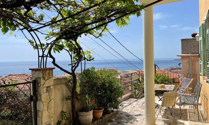 Menton Apartment | Terrace with stunning sea view and pergola with vines