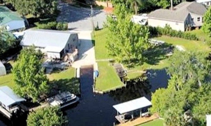 Astor House | The Launch Pad - House with boat ramp on corner deep water canal lot