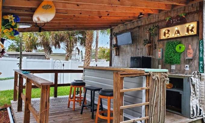 Edgewater House | The Tiki Hut Oasis, a tropical Beach home with firepit, patio, and more!