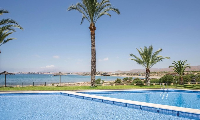 Los Puertos Apartment | This vacation apartment with modern equipment offers a magnificent view of the sea and the huge pool