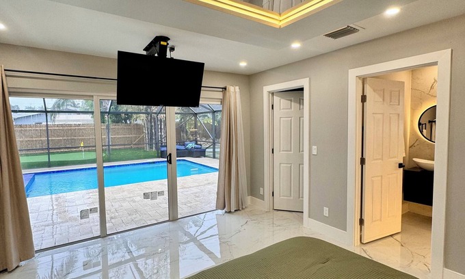 West Palm Beach Villa | Tropical Luxury Retreat with warm Pool, 5-bedroom & Mini Golf, Impact Windows