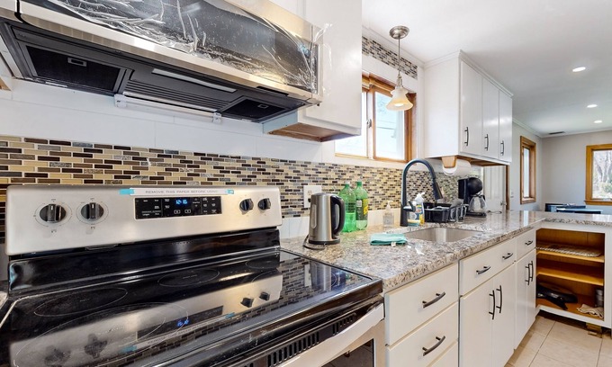 Sandown House | Two-story dog-friendly home with a lake view, deck, gas grill