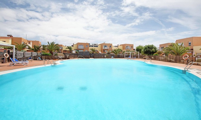 Corralejo Apartment | Vacation Home "Las Fuentes Corralejo" with Mountain View, Shared Pool & Wi-Fi