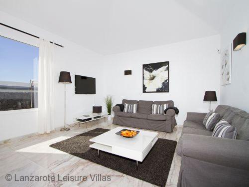 Puerto del Carmen Villa | Villa Benedicte sea view, heated pool, bedroom A/C, WiFi, SKY, short walk to Puerto del Carmen
