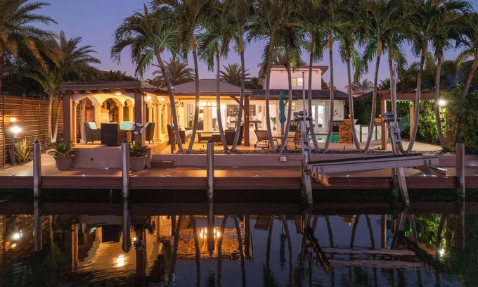 Sunset House | Villa Les Palmieres, a lush waterfront residence with pool and dock