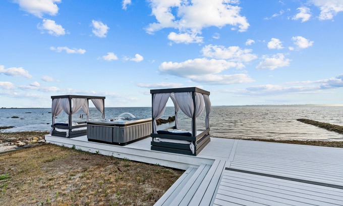 Fairhaven House | Waterfront Oasis with day beds and hot tub with captivating sunsets.