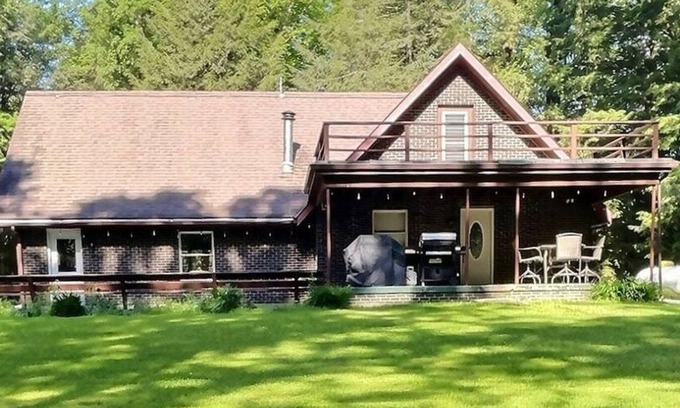 Brookville House | Welcome to your perfect getaway! Nestled on a semi-secluded 2-acre lot, this charming brick Cape Cod is centrally located between Cook Forest and Clear Creek State Parks. Surrounded by trees, this cozy retreat offers a peaceful escape.