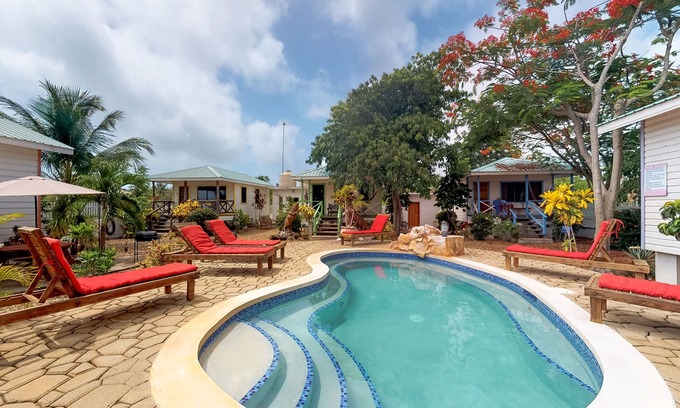 Hopkins Apartment | Wood cabana with a porch, pool view, WiFi, and a shared common area with grills