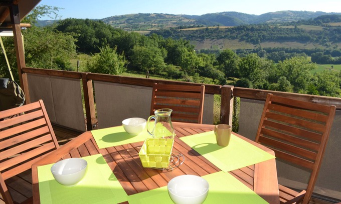 Bessuejouls RV Rental | Wooden Chalet in Bessuéjouls – Glamping Lodge with Private Terrace, Garden, and Mountain View