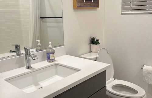 Upland House | Beautiful bedroom 02 with a private bathroom featuring a tub and shower.