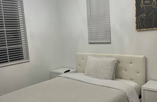 Upland House | Beautiful bedroom 02 with a private bathroom featuring a tub and shower.