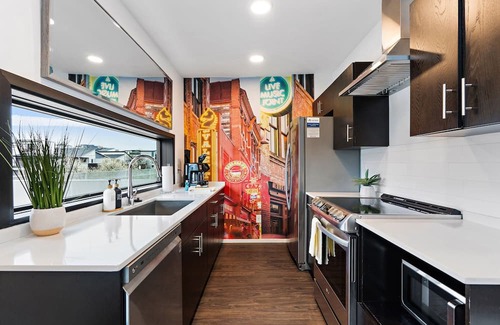 The Gulch Condo | Urban Condominium: Featuring a Pool and Balcony in a Contemporary Mid-Rise