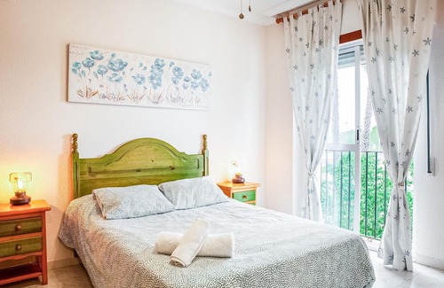 El Portil Apartment | Enjoy a relaxing vacation in this inviting vacation home with a community pool.