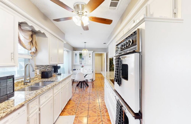 Private home with enclosed backyard, gas grill, sunny interior, & smart TVs