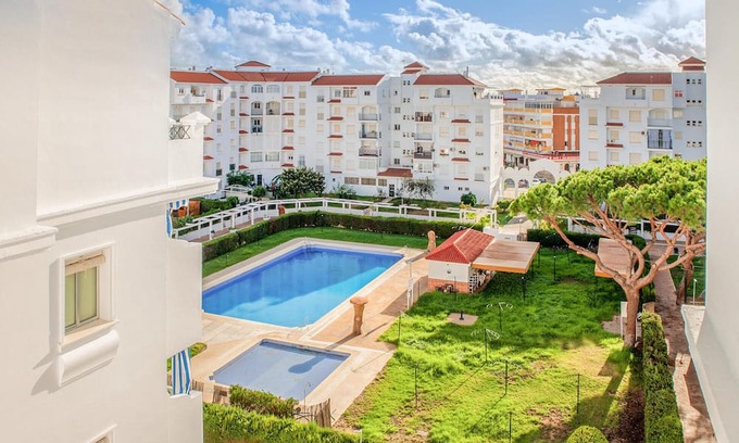 El Portil Apartment | Enjoy a relaxing vacation in this inviting vacation home with a community pool.